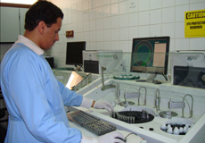 Healthcare worker in the laboratory with caution sign on the wall
